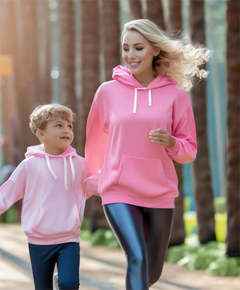 Woman running with a boy in the forest.